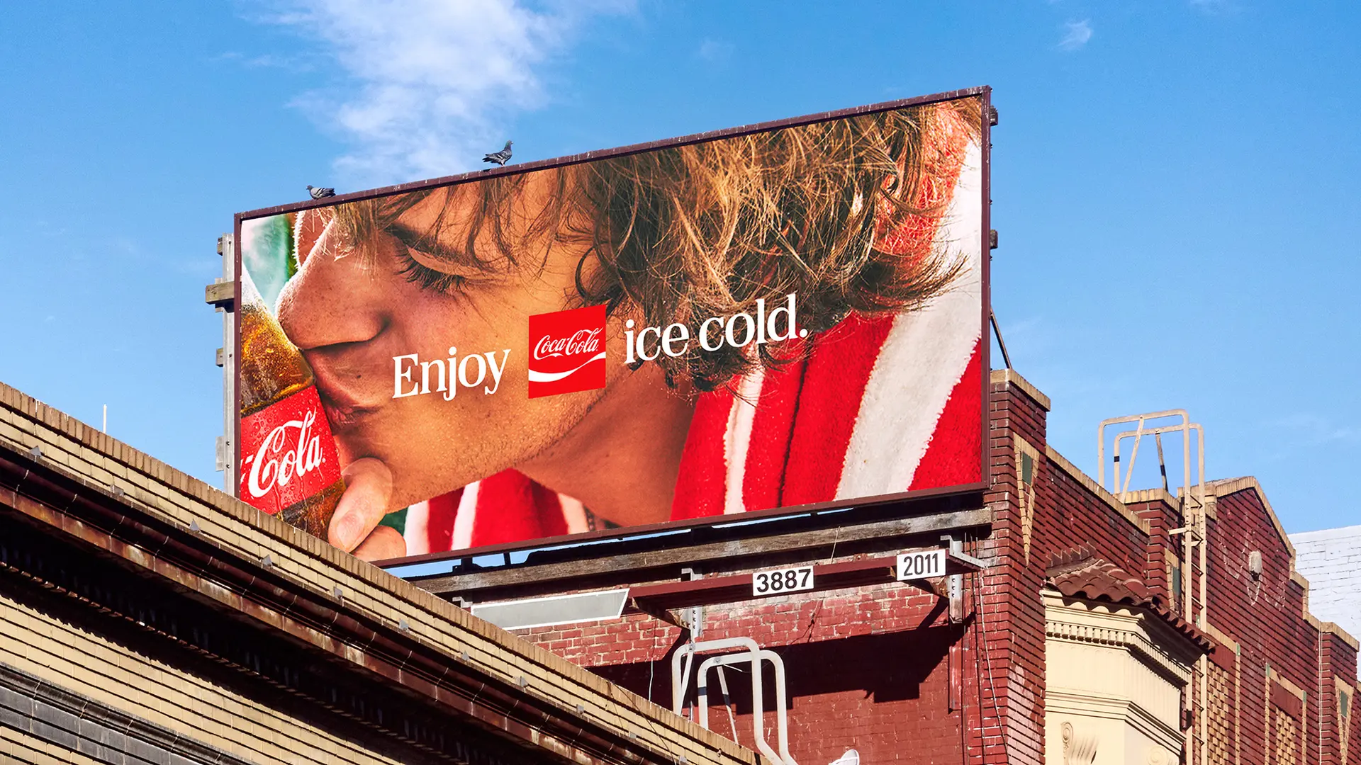 Coca‑Cola billboard: close-up of person drinking from glass bottle