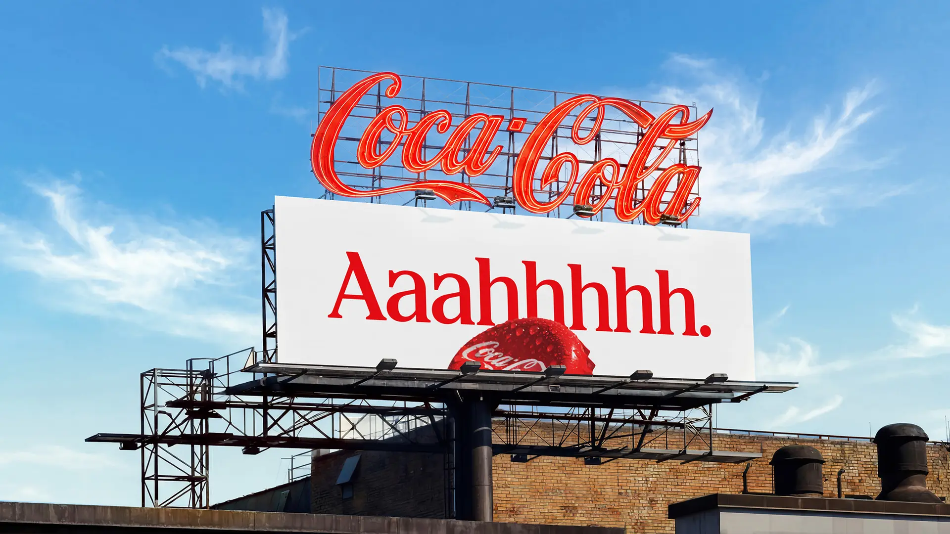 Coca-Cola rooftop neon sign above billboard reading "Aaahhhhh."