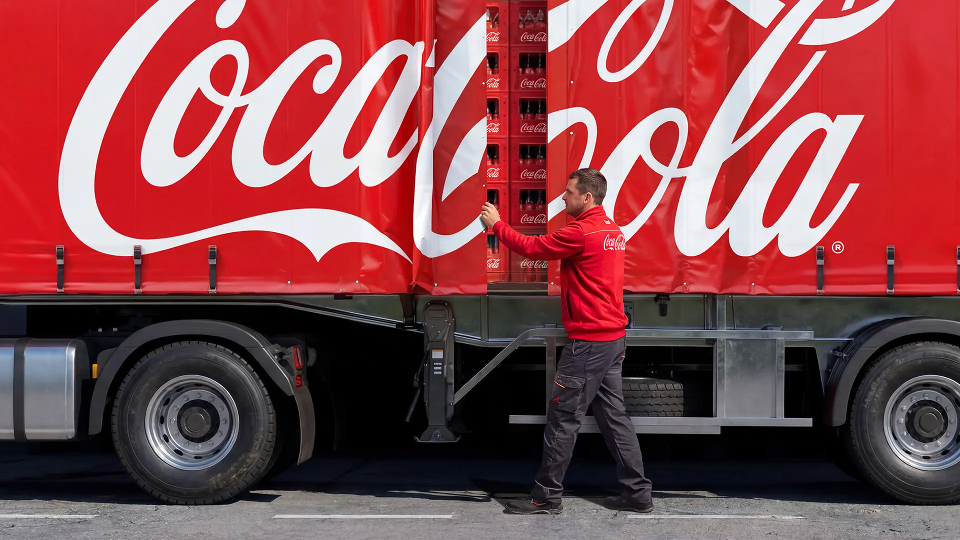 Coca-Cola curtain-side delivery truck with stacked beverage cases