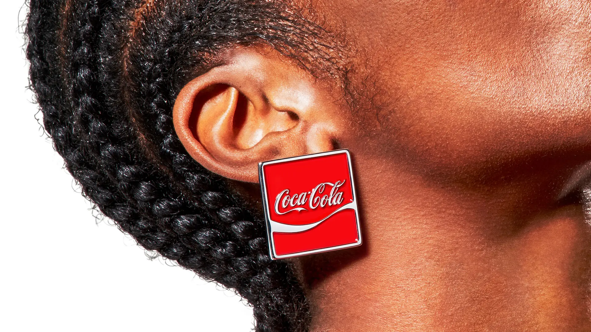 Coca‑Cola red square enamel earring on model's ear (product shot)