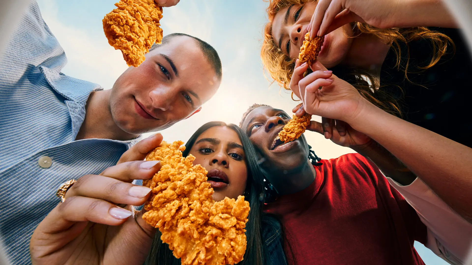 KFC advertising photo — low-angle close-up of oversized crispy fried chicken
