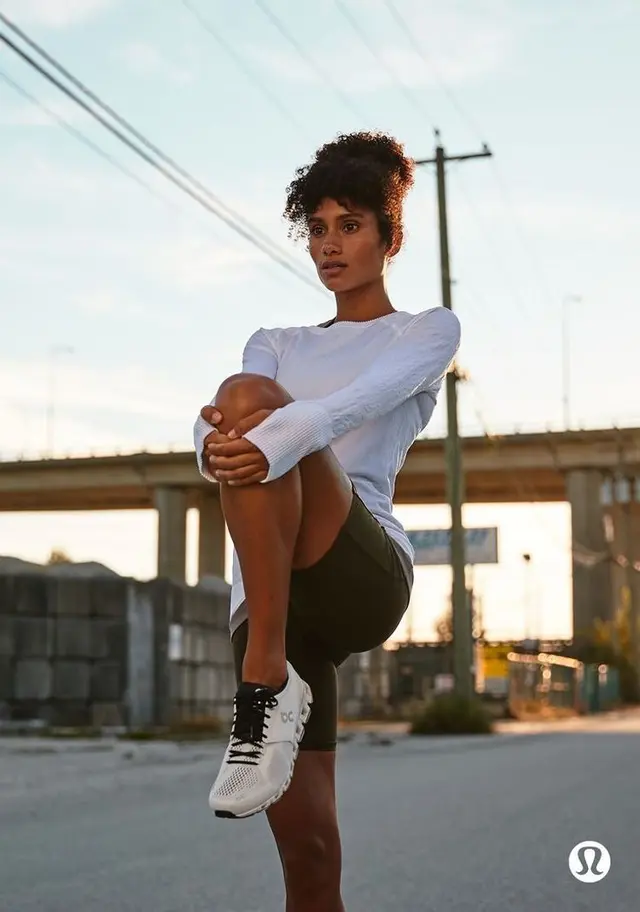 Urban athlete stretching under overpass — Lululemon-style campaign image