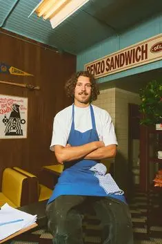 Portrait of sandwich shop worker in retro diner interior
