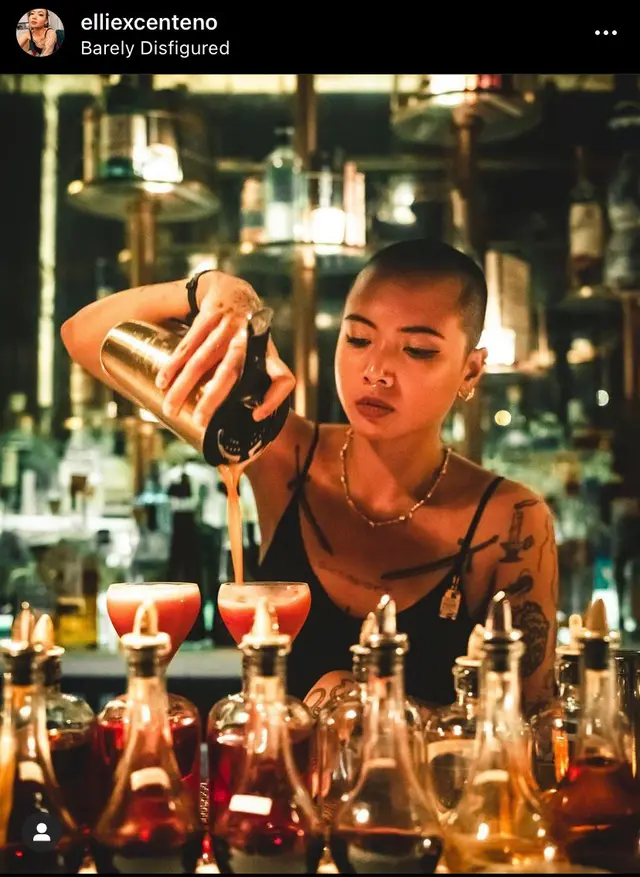 Mixologist Pouring Cocktails in Amber-lit Bar — elliexcenteno