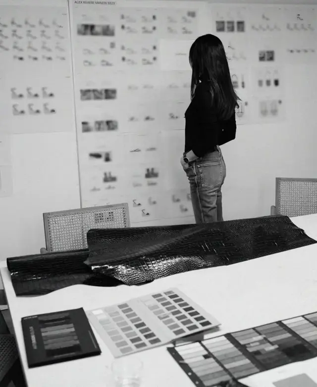 Design studio moodboard with leather sample and color swatches (black & white)