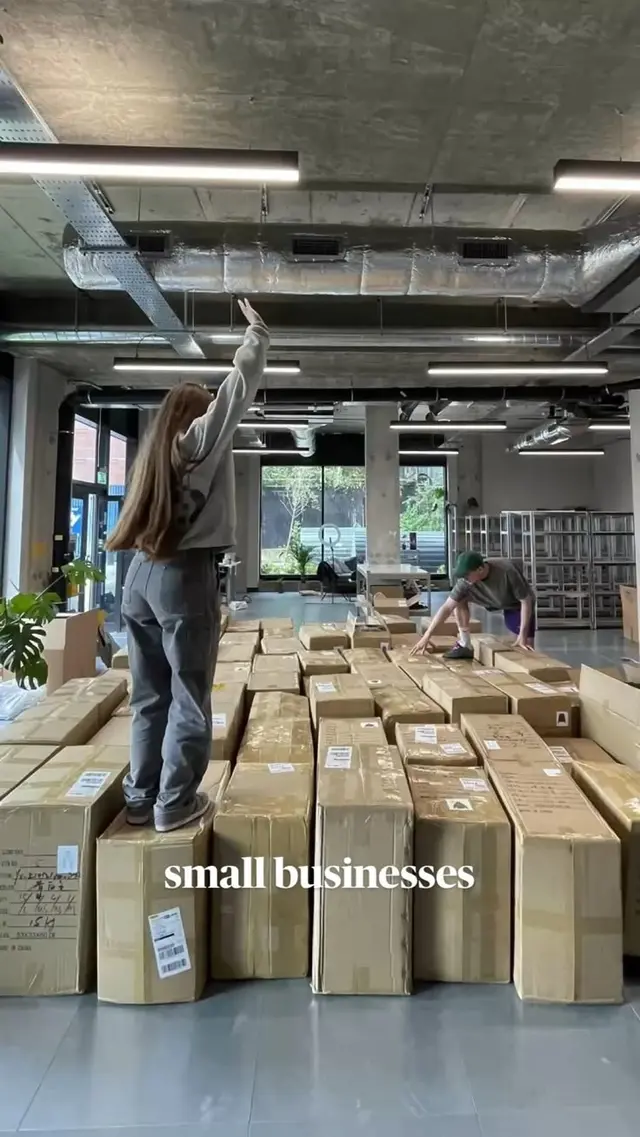 Industrial workspace stacked with cardboard shipping boxes — text overlay 'small businesse