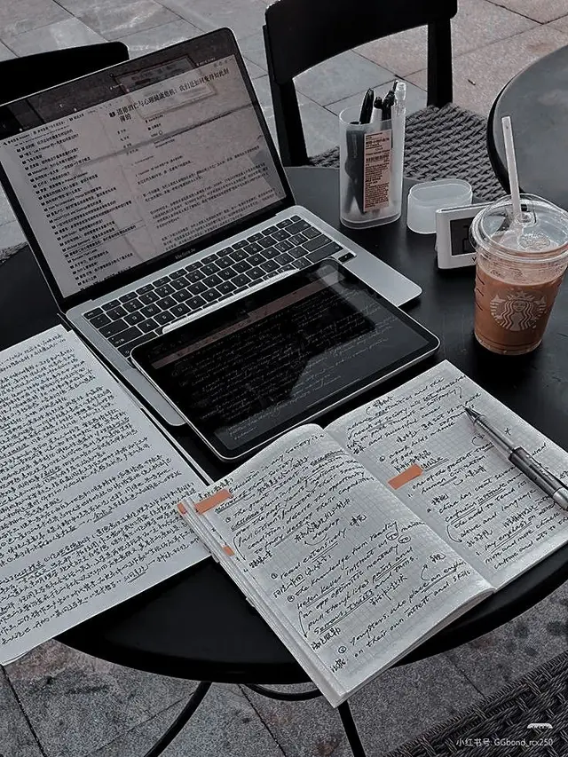 Cafe study setup with MacBook, iPad, handwritten Chinese notes and Starbucks iced coffee