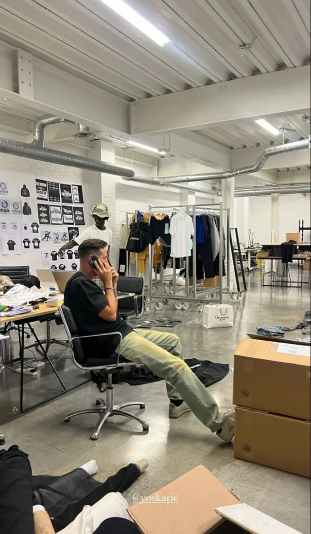 Fashion studio sample room with garment racks and packing boxes