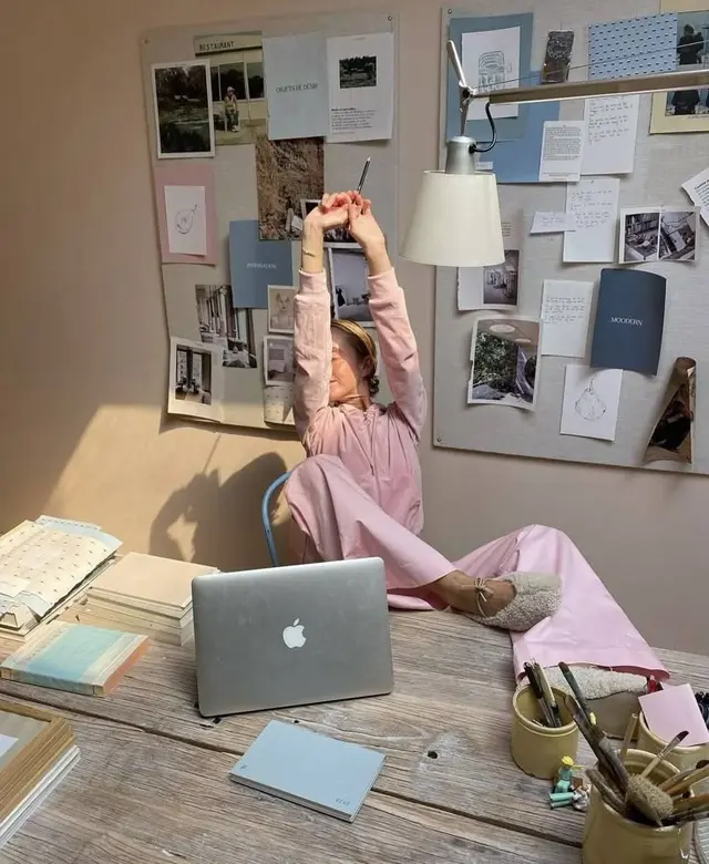 Pastel creative workspace with MacBook and moodboard