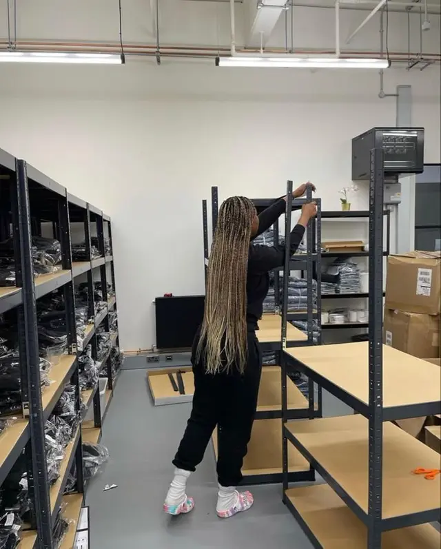 Backroom stockroom with boltless metal shelving and packed apparel