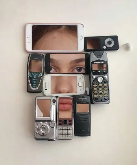 Human face framed by arranged vintage mobile phones and iPod-style player