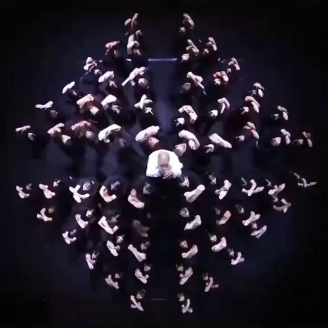Top-down radial dance formation on dark stage