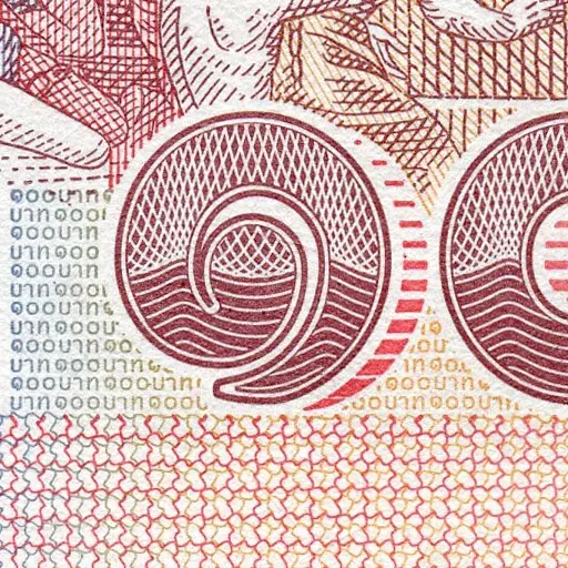 Macro close-up of banknote security printing with maroon guilloche numeral