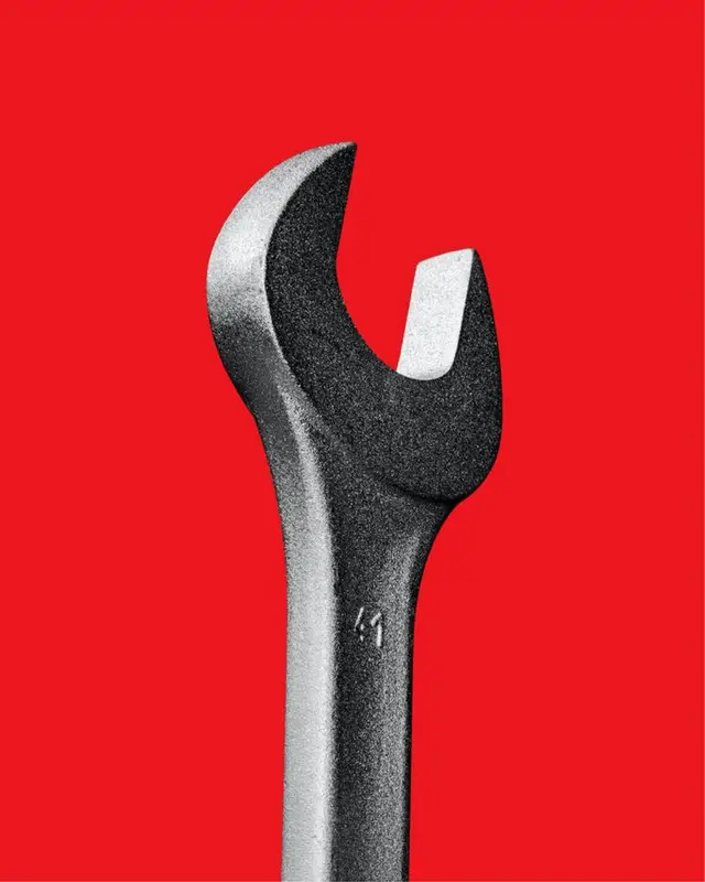 Close-up open-end wrench on red background
