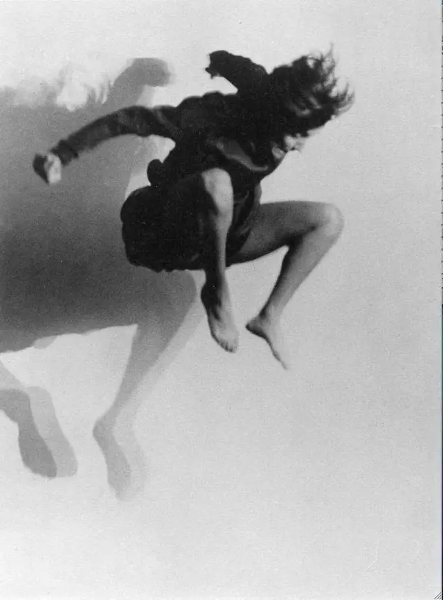 Black-and-White Studio Photo — Barefoot Jumper Casting Layered Shadows