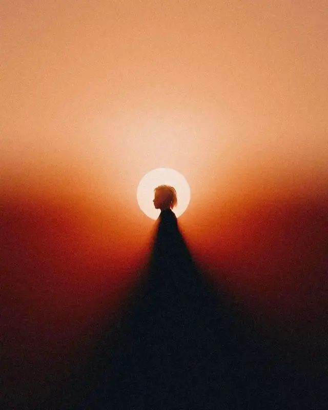 Centered Silhouette with Haloed Sun and Long Shadow