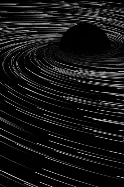 Monochrome spiral star trails around central void — black hole illustration