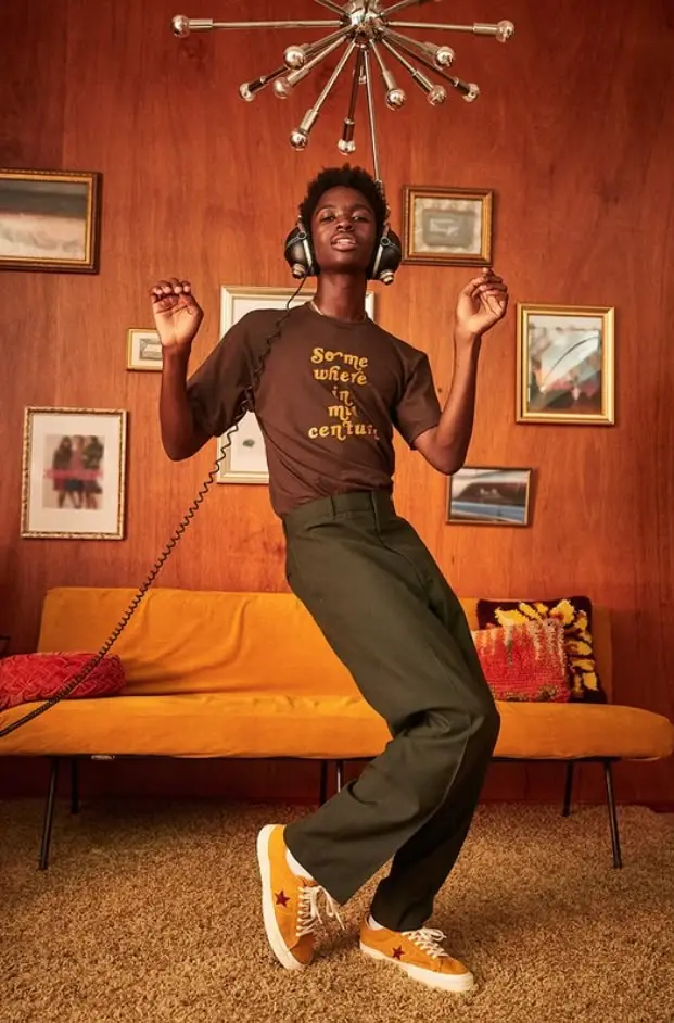 Retro living room fashion shoot — person dancing with headphones