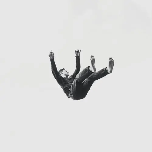 Black-and-White Photograph — Person Falling Mid-Air, Barefoot