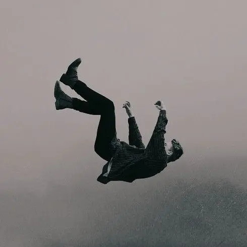 Solitary figure suspended in monochrome fall