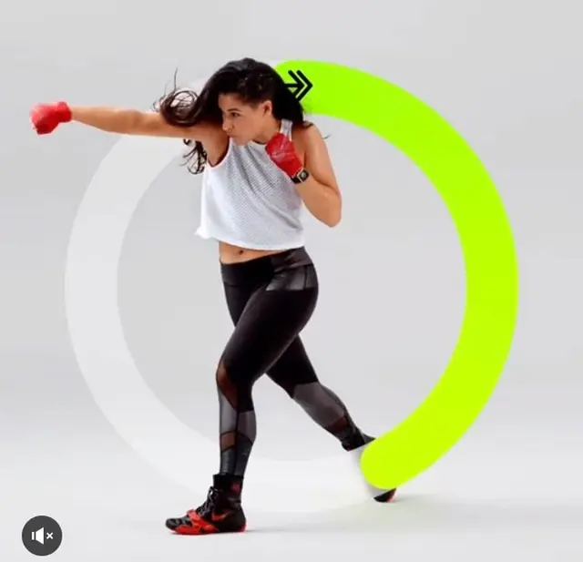 Studio fitness image — woman boxing with neon progress ring