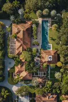 Aerial view — Mediterranean‑style estate with terracotta roofs and rectangular lap pool