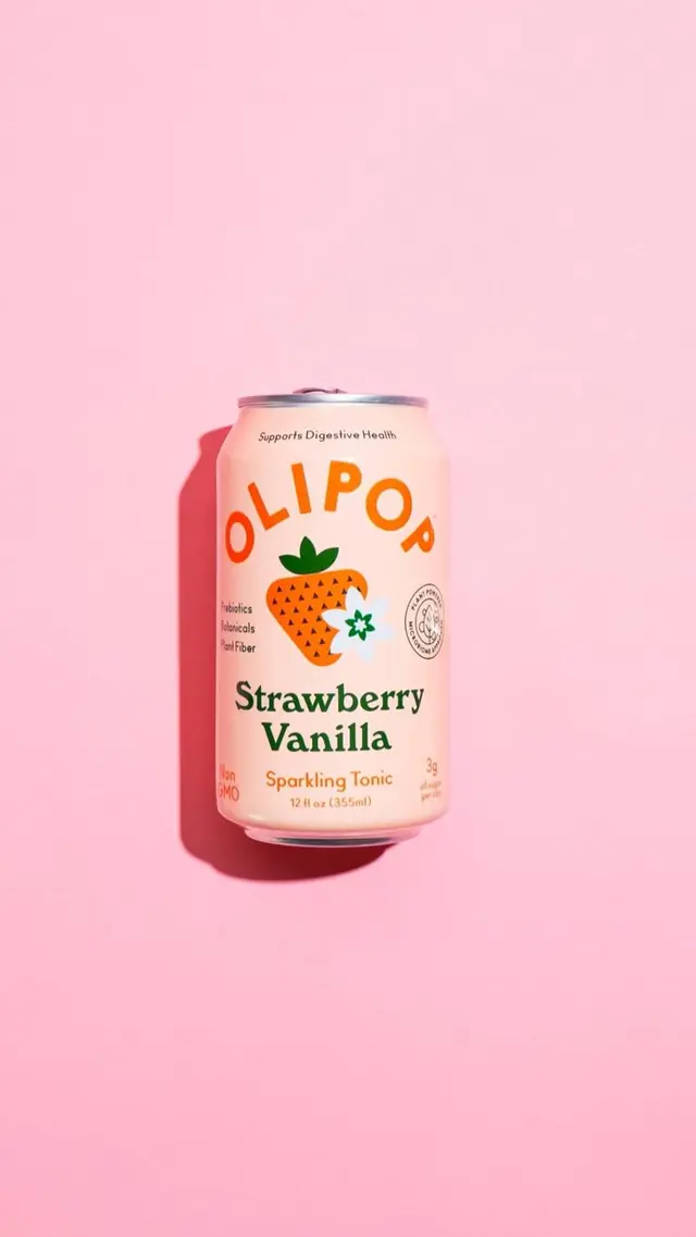 Olipop Strawberry Vanilla sparkling tonic can on pastel pink background