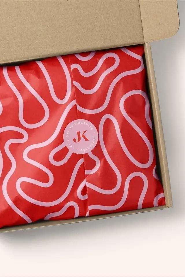 Kraft shipping box with custom pink printed tissue, baker's twine and branded stickers