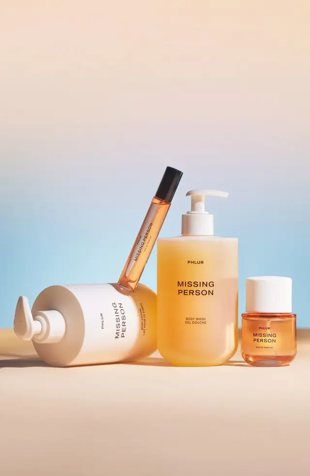 PHLUR "Missing Person" fragrance + body wash set — minimalist amber product shot