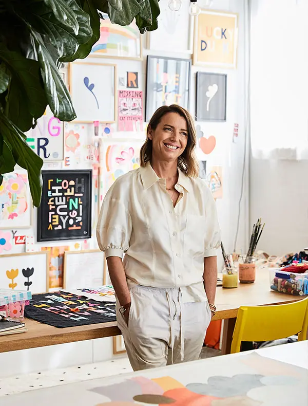 Rachel Castle in Marrickville studio with gallery-wall prints and worktable