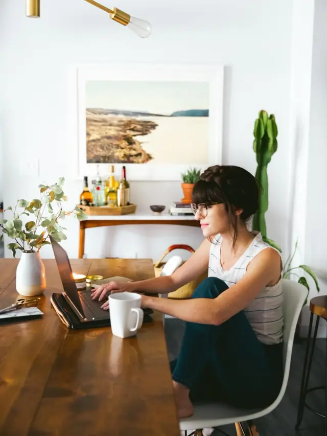 Blogger at home workspace with laptop and coffee — New Darlings