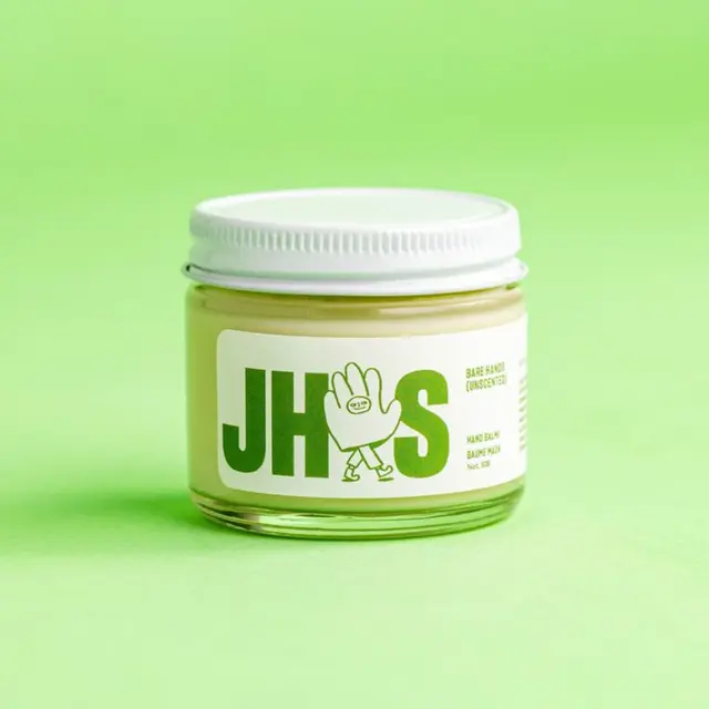 Just Hand Stuff — yellow balm in glass jar with bold 'JHS' label