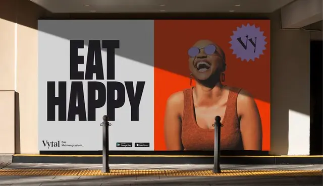 Vytal billboard — “EAT HAPPY” campaign with laughing woman