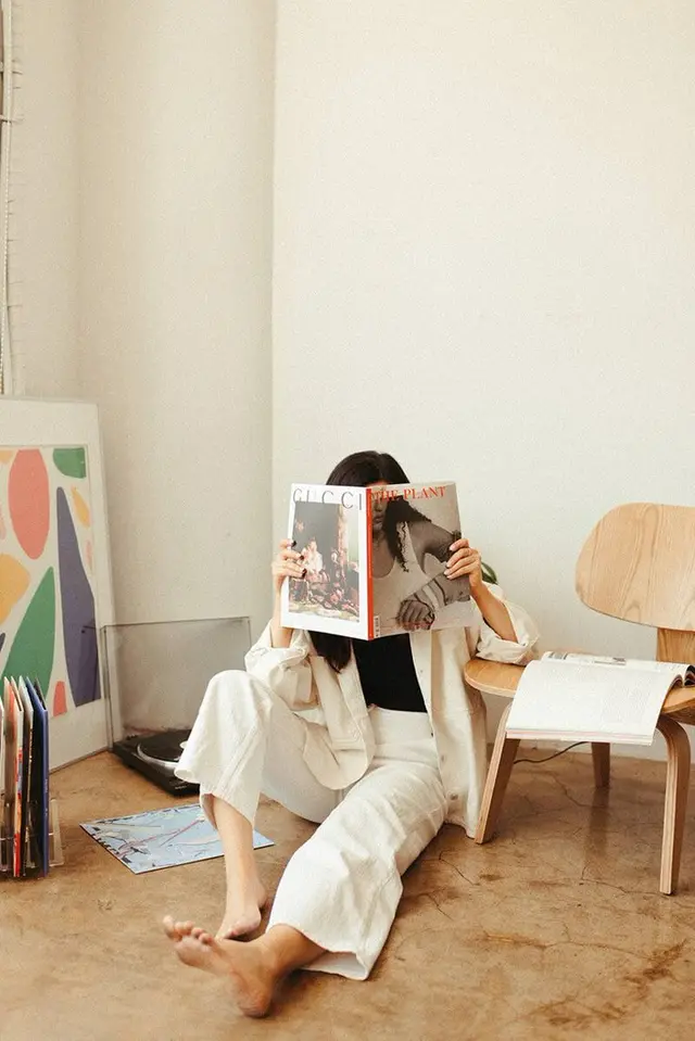 Jess LA brand session — woman reading THE PLANT magazine in minimal studio