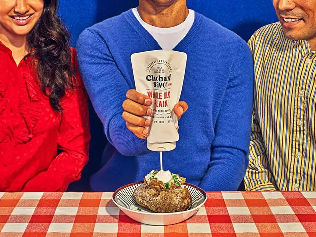 Chobani Savor Low‑Fat Plain pouch used as condiment on chili — product packaging shot