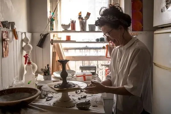 Margaret Braun in Her Porcelain Studio Surrounded by White Ceramic Vessels