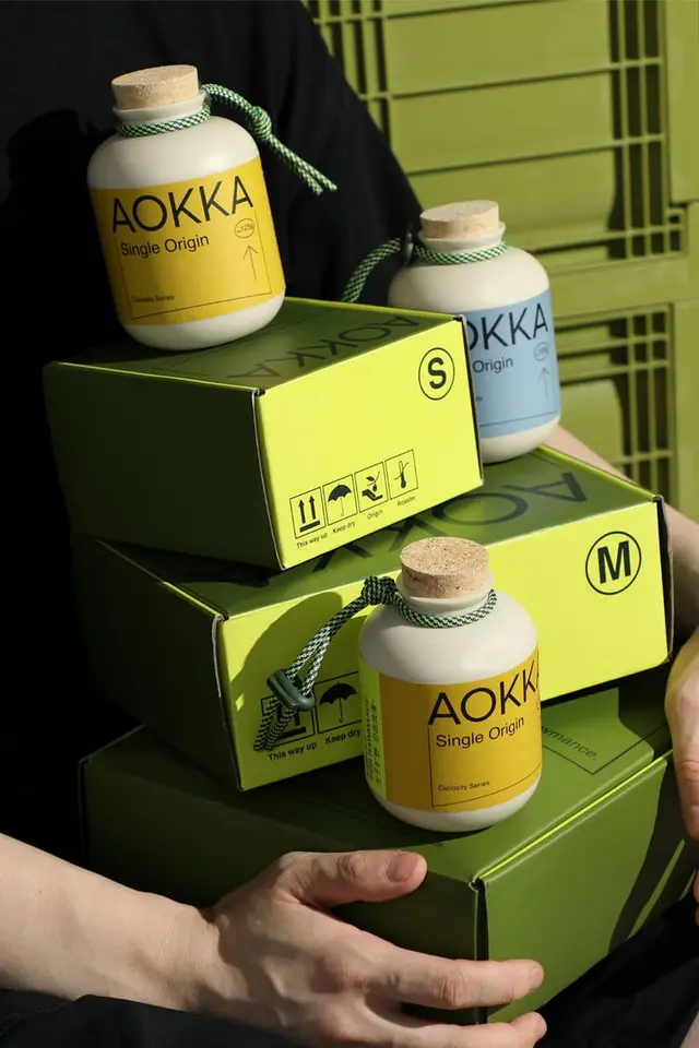 AOKKA olive-green jerrycan coffee packaging — embossed logo by low key Design