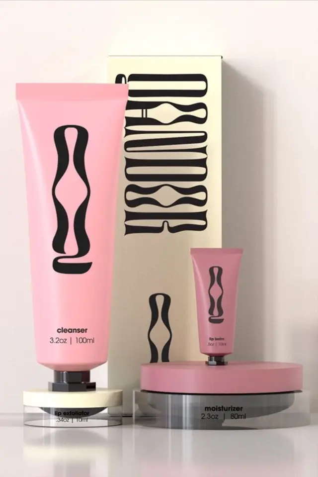 Qandor skincare packaging — pastel pink frosted bottles and bold black logomark