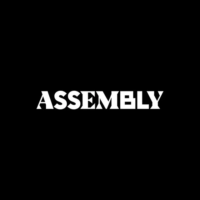 Assembly door hanger — bold 'OUT' typography in red-orange (Ragged Edge)