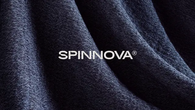 SPINNOVA wordmark on draped dark-blue textile — Studio Marina Veziko branding image