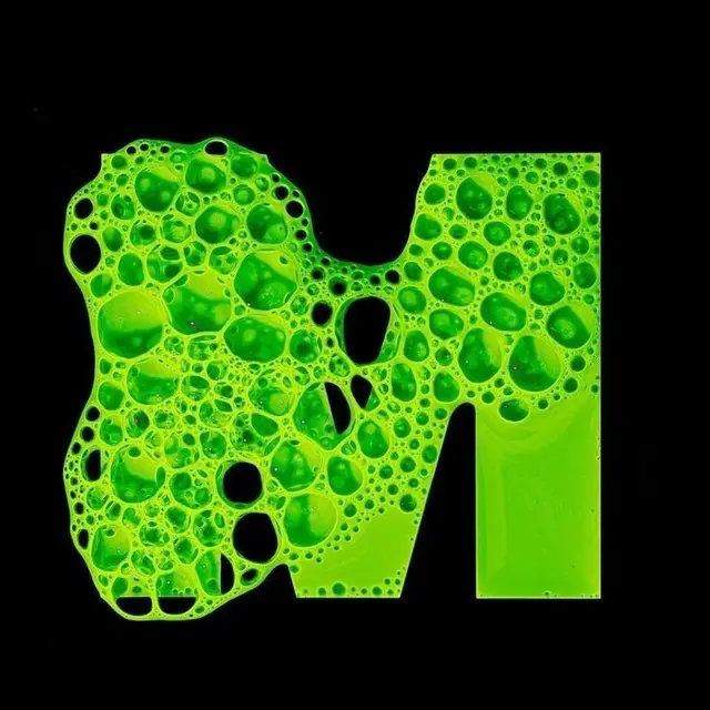 Neon green bubble-filled letter M on black background