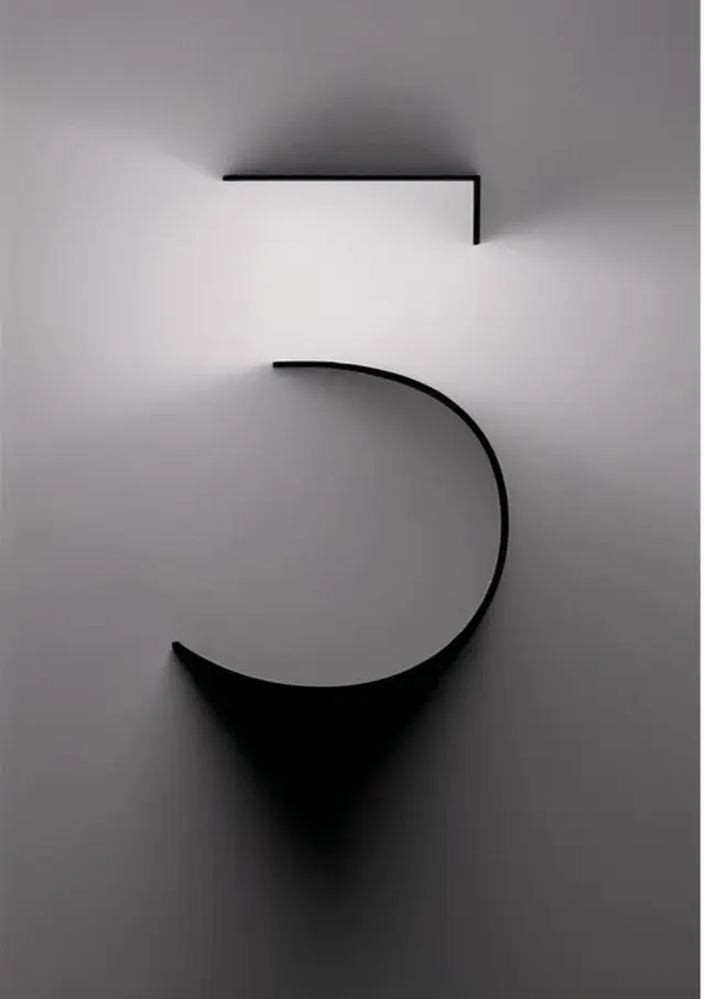 Minimalist wall sculpture of the numeral 5 in matte black