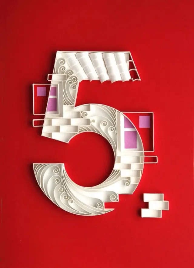 Layered white paper numeral 5 with filigree on red background