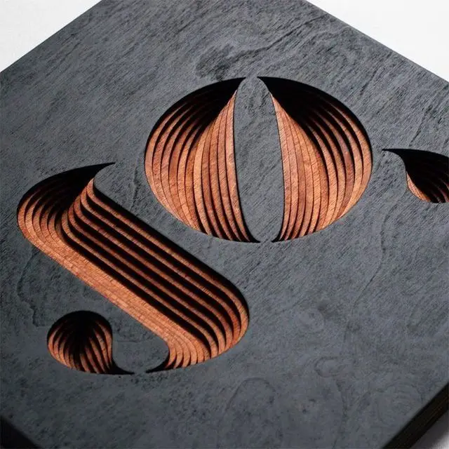 Layered carved plywood relief with dark-stained top