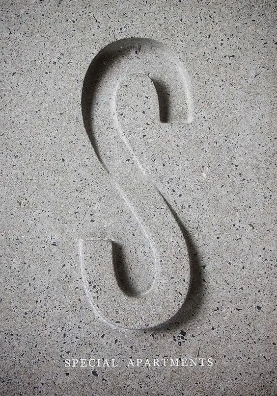 Carved concrete 'S' with serif signage