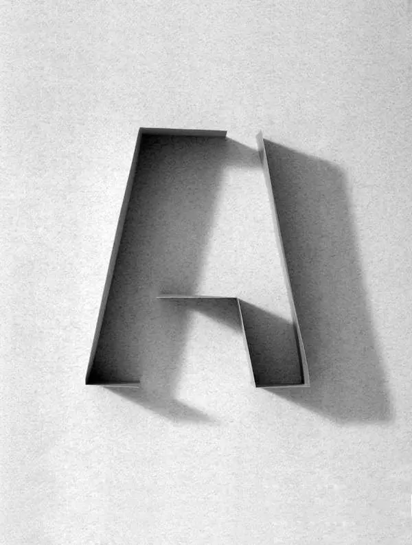 Folded strip forming letter A with dramatic cast shadow