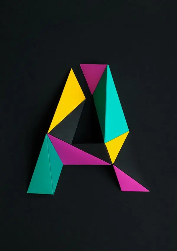 Papercraft Geometric Letter A — Cyan, Magenta, Yellow on Black