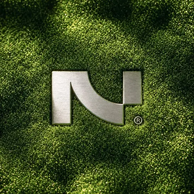 Brushed-metal stylized 'N' logo recessed in moss texture