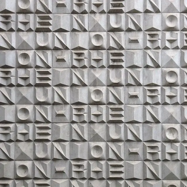 Modular precast concrete relief facade — geometric grid panels