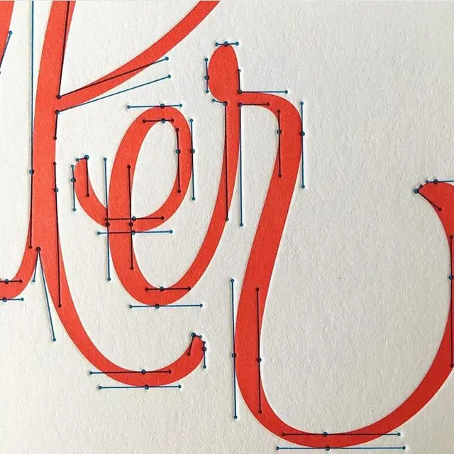 Close-up red script lettering with Bézier anchor points overlay